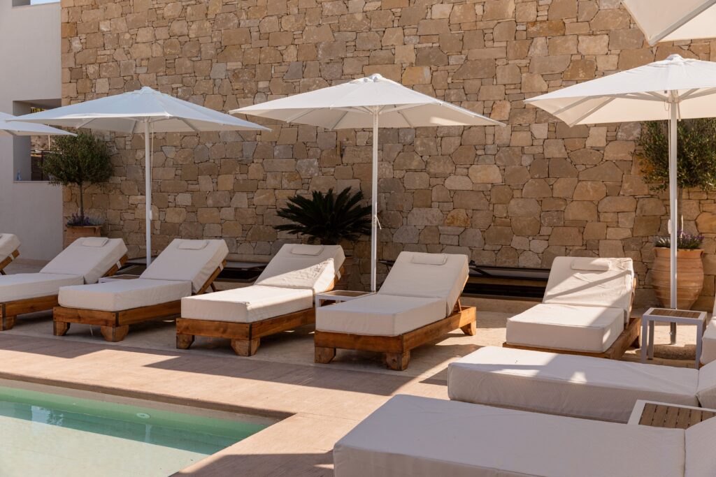 Inviting pool area surrounded by lush greenery and sun loungers